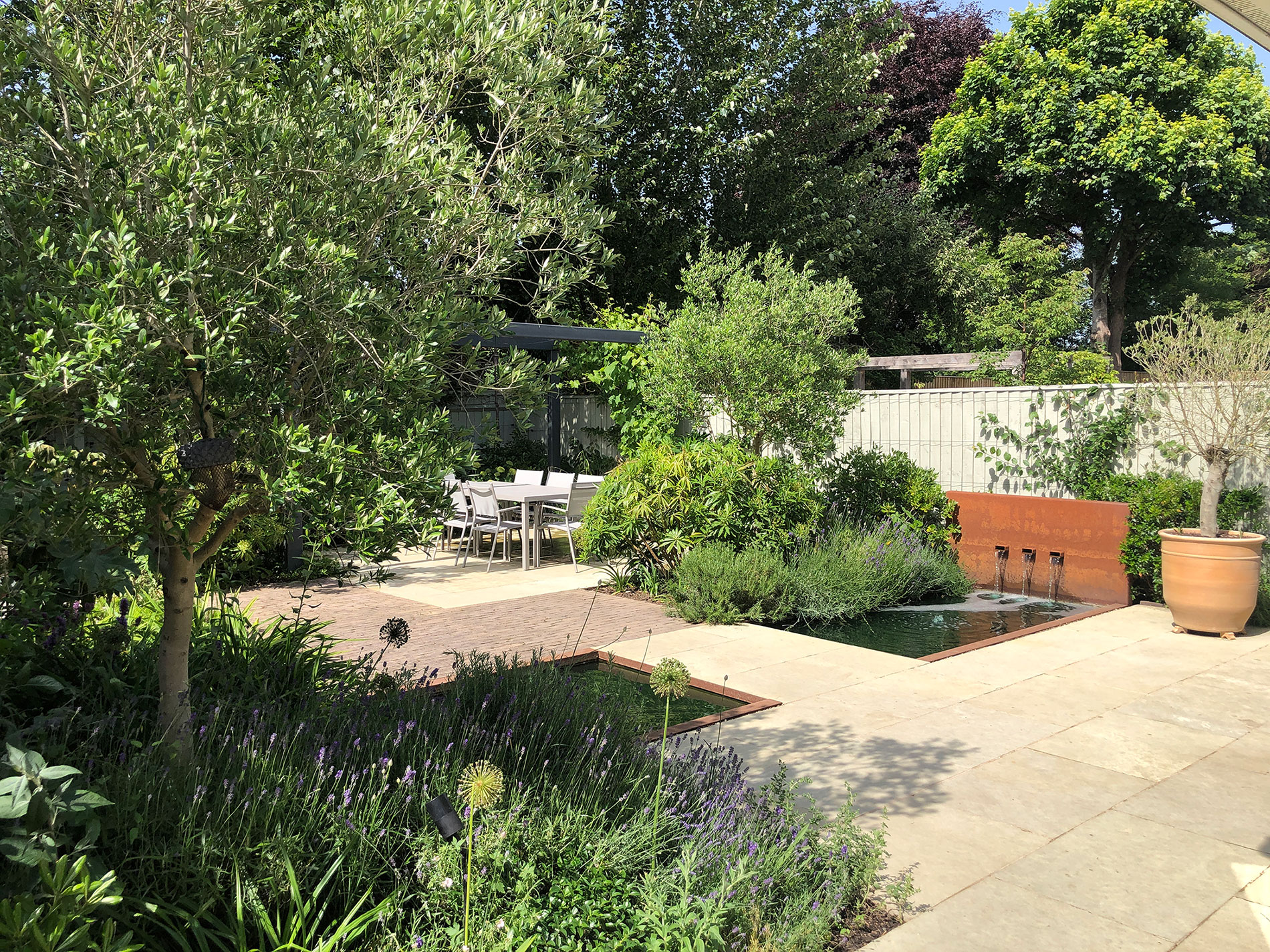 An overview of garden in Tring with signature steel water feature