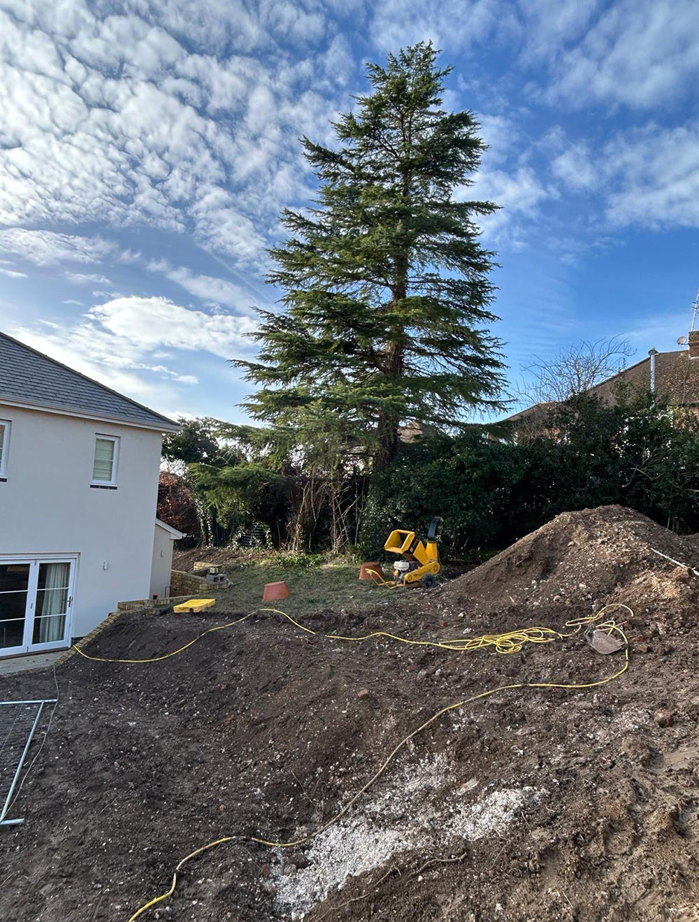 Garden under construction in Berkhamsted, a large Cedrus deodara tree overlooks the site.