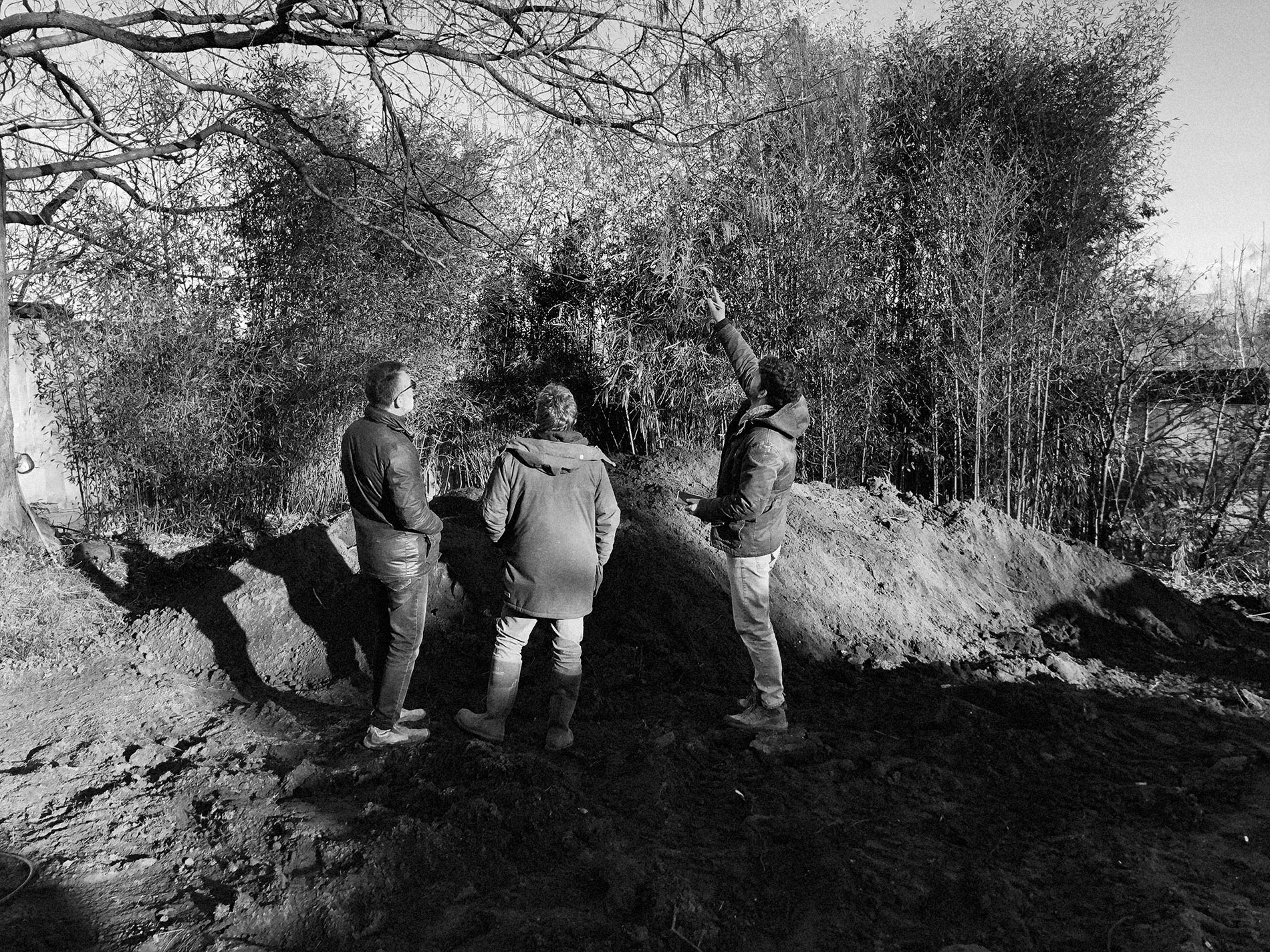 Simon chasey and Jules Cant discuss the site of a new garden with a client